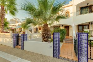 a palm tree in front of a building at soleadore sol in Orihuela