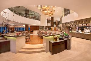 a hotel lobby with a bar and a restaurant at Crowne Plaza Greater Noida, an IHG Hotel in Greater Noida