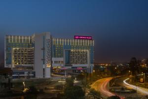 a building with a sign on top of it at night at Crowne Plaza Greater Noida, an IHG Hotel in Greater Noida