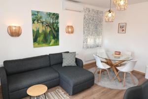 a living room with a couch and a table at Apartman Krinka in Vrnjačka Banja