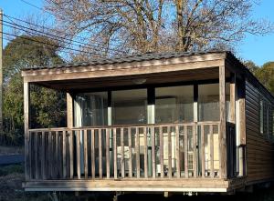 a screened in porch on a house at Camping La Prairie in Le Muy