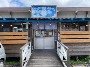 a building with a wooden walkway leading to a door at Southern Village Okinawa in Kitanakagusuku