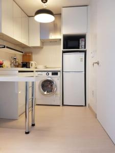 a kitchen with a refrigerator and a washing machine at Sam House 154 - Center of SEOUL in Seoul