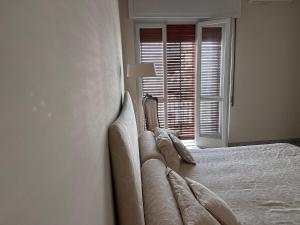 a white bed in a room with a window at house green station in Bari +5 photos
