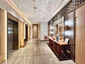 a lobby of a hotel with a desk in a hallway at Landmark International Hotel in Guangzhou