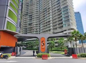 a train in front of a tall building at Sky Suite KLCC Studio Suite in Kuala Lumpur