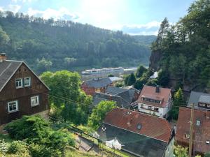 a view of a town with a river and buildings at Haus Bergfriede in Bad Schandau