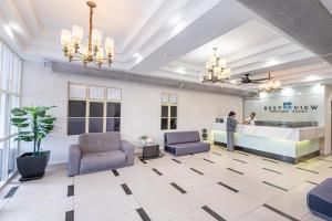 a lobby with two chairs and a reception desk at Swing & Pillows - USJ Taipan in Subang Jaya