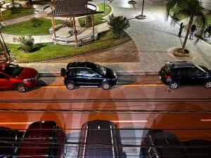 two cars are parked on a street in a city at Makai - Nayarak Paracas in Paracas
