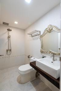 La salle de bains est pourvue d'un lavabo, de toilettes et d'un miroir. dans l'établissement Swing & Pillows - USJ Taipan, à Subang Jaya