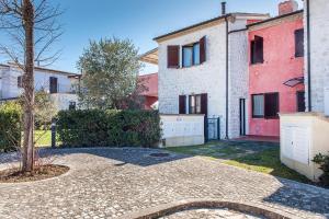 an exterior view of a house with a tree at M347 - Marcelli, comodo trilocale nuovo con piscina e giardino in Santa Maria a Potenza