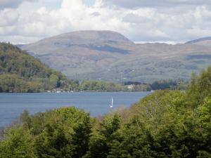 a view of a lake with a boat in the water at Sandown in Bowness-on-Windermere