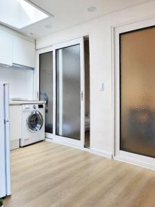 a kitchen with a washer and dryer in a room at Sam House 2 Seochon in Seoul