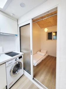 a kitchen with a washer and dryer in a room at Sam House 2 Seochon in Seoul