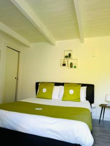 a bedroom with a large bed with yellow pillows at La Casa Particular in Bari