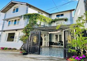 a white house with a gate in front of it at NHỚ House IV in Da Lat