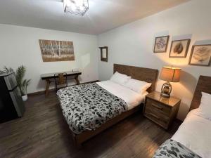 a bedroom with a bed and a desk in it at Arctic Divide Lodge in Dease Lake