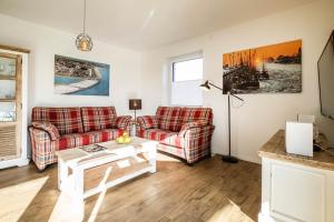 Posezení v ubytování Haus Strandläufer Apartment 1 6 DeichLounge