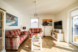 TV a/nebo společenská místnost v ubytování Haus Strandläufer Apartment 1 6 DeichLounge