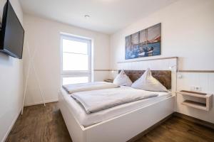 Postel nebo postele na pokoji v ubytování Haus Strandläufer Apartment 1 6 DeichLounge