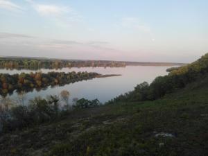 a view of a lake with trees in the distance at Vinarija Stojanovic in Slankamenački Vinogradi