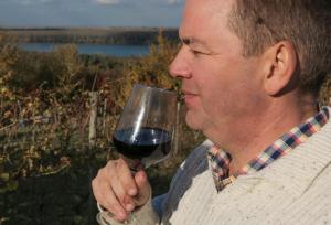 a man drinking a glass of red wine at Vinarija Stojanovic in Slankamenački Vinogradi