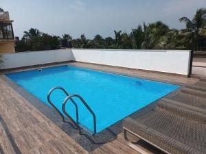 a swimming pool on the roof of a building at Hotel Calangute Central in Calangute