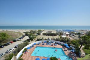 una vista panoramica su una piscina in un resort con spiaggia di Hotel Bellevue Beach - sul mare a Milano Marittima