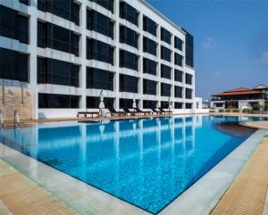 a swimming pool in front of a building at Lao Plaza Hotel in Vientiane