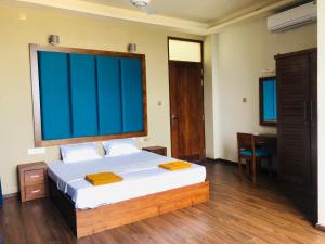 a bedroom with a large bed and a desk at GRAND BOLGODA RESORT in Moratuwa