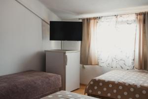 a small bedroom with a bed and a window at Apartments Djukic in Tivat