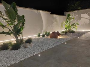 a garden with two stuffed animals sitting on the gravel at B&B La Porta sul Mare a Porto Cesareo in Torre Squillace