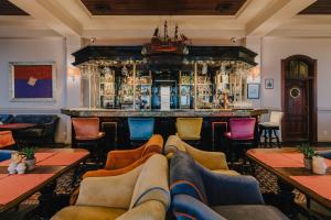 a bar with chairs and a couch in a restaurant at Zamek Łeba Resort & Spa in Łeba