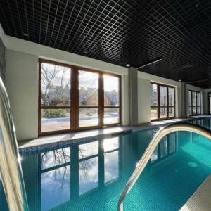 a large swimming pool with a large window in a building at C4 Podgrzewany basen sauna, nowy Revist Szklarska in Szklarska Poręba