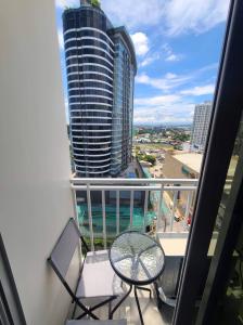 a balcony with a table and chairs and a building at INSPIRIA Condo Free Airport Pickup for 3 nights stay or more in Davao City