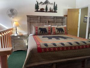 a bedroom with a bed with a wooden headboard at Lifts West 208 With Wifi in Red River