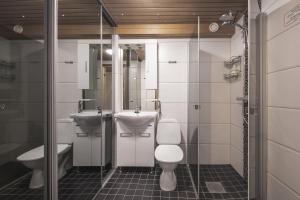 a bathroom with two toilets and a sink and a shower at Holiday Home Tintintaival in Tahkovuori