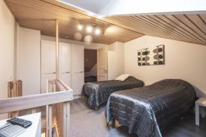 a room with two beds and a mirror in it at Holiday Home Tintintaival in Tahkovuori