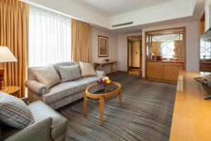 a living room with a couch and a table at RSL Hotel Taipei Zhonghe in Zhonghe