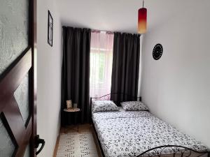 a bedroom with a bed in front of a window at Cozy Apartment in Turnu Măgurele