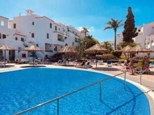 a large swimming pool in a resort with white buildings at Elegant apartment in Amarilla Golf - FW 411 in San Miguel de Abona