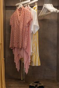 a display of clothes on a hanger in a closet at Elena Hotel Mykonos in Mikonos