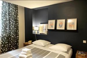 アヴィニョンにあるMatisse 50 - Appartement Avignon centreの黒い壁のベッドルーム1室(ベッド1台付)