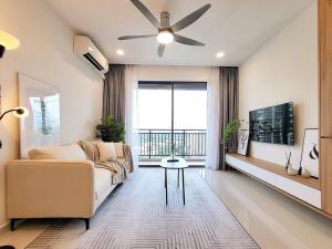 a living room with a couch and a ceiling fan at Panoramic Skyline View - 3 Bedrooms 6 Pax - Free Parking in Johor Bahru