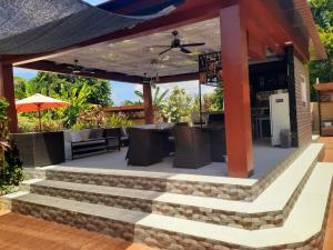an outdoor patio with a table and chairs at Villa casamarbella in Karangasem