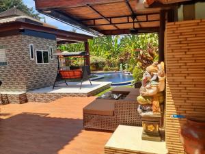a patio with a swimming pool and a house at Villa casamarbella in Karangasem