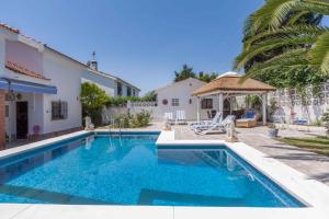 a swimming pool in front of a house at Stunning Villa with private pool Ref 30 in Santa Fe de los Boliches