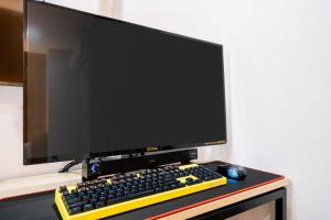 a computer monitor and a keyboard and mouse on a desk at Hotel Haeseong in Changwon