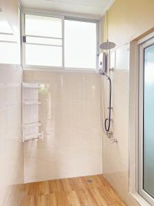 a bathroom with a shower and a window at Private house Casa seaside Rayong in Ban Chak Phai