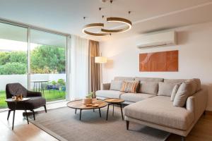 a living room with a couch and a table at Hiddenbay Teos Sığacık Hotel, Spa and Restaurants in Seferihisar